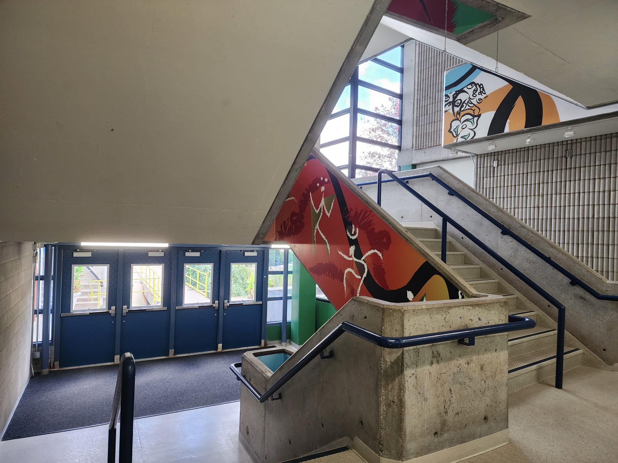 In the B-wing there are concrete stairs that have colourful art on the sides of the stairs. This highlights the fact that this is an art school and adds a splash of colour to a rather dull area.